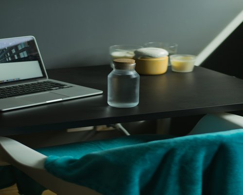 Water glass on office desk near laptop