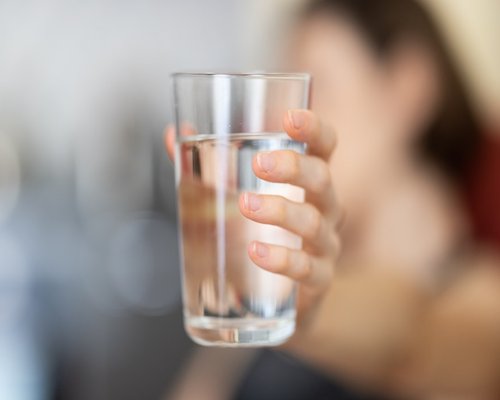 A person taking a short rest with a glass of water